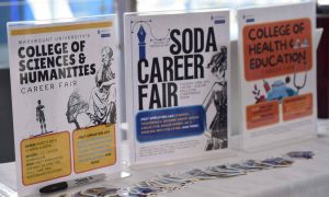 College of Sciences & Humanities, SODA, and College of Health & Education career fair signs.