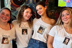Seniors pose in matching t-shirts during Senior Week