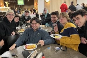 Students sit together enjoying late night breakfast