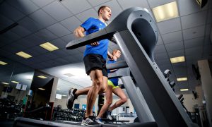 People run on a treadmill in a gym