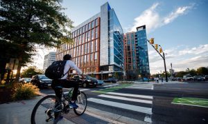 A student bikes to the Ballston campus