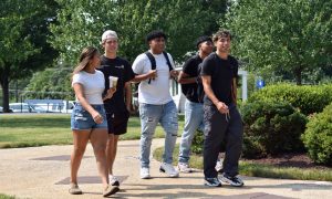 A group of students walks through campus