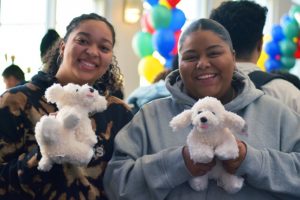 Students hold stuffed animal dogs from Bernie's Birthday