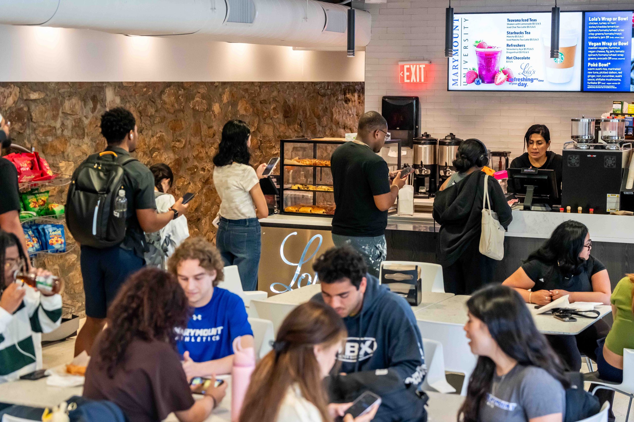 Students stand in line to order at a cafe