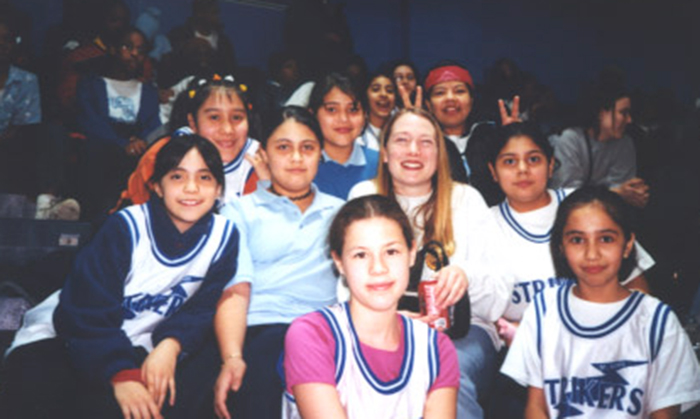 Dr. Jennifer Gray coaching a girl's basketball team at St. Agnes of Bohemia School