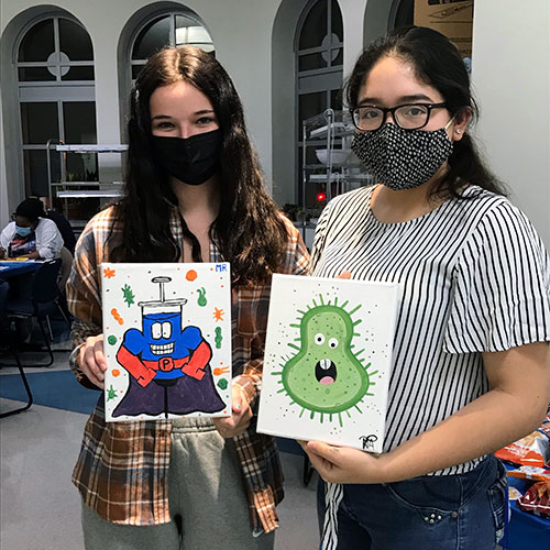 Marymount students participating in a ‘Paint and Sip’ event to raise awareness about the antibiotic crisis.