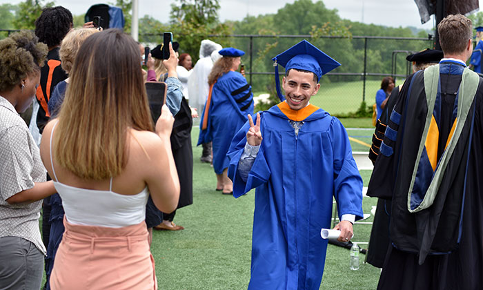A Marymount student celebrates receiving his diploma