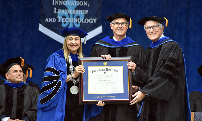 Christopher Nassetta (center) receives honorary degree during the College of BILT commencement ceremony