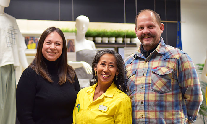 Julia Ravindran, Wendy Rogers and School of Design and Art Director Joe Hicks pose in front of the exhibition
