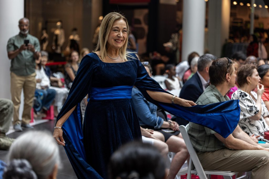 President Irma Becerra models a gown created by sophomore designer Bria Fisher at Portfolio in Motion (courtesy of Will Nelson)