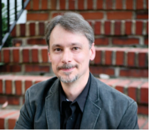 John Rowles smiles for a headshot
