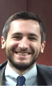 Carlos Benavides smiles for a headshot.