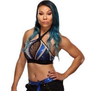 Stephanie Yim Bell poses for a photo in her wrestling attire.