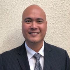 Paul Richard Tan smiles for a headshot