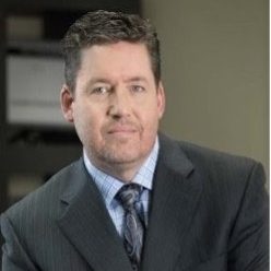 Peter Market smiles for a headshot