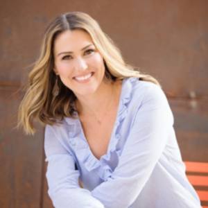 Carey Schuster smiles for a headshot.