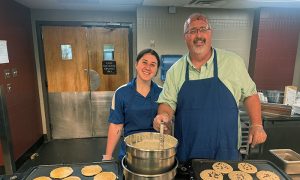 Craig and her father, Jason, serve the Marymount community at a late-night breakfast