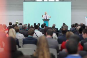 A presenter speaks to a captivated audience