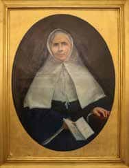 A portrait of Mother St. Jean, clothed in her habit and holding a book.