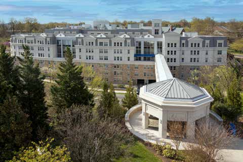 An aerial photo of the tunnel-bridge to Rose Benté Lee Ostapenko Hall and the hall itself