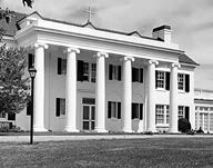The front of the administration building with it's columns and rooftop cross
