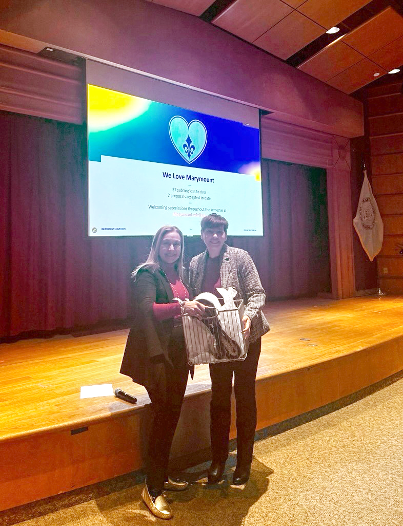 President Irma Becerra stands next to and presents Kristina Deemark with an awardee basket