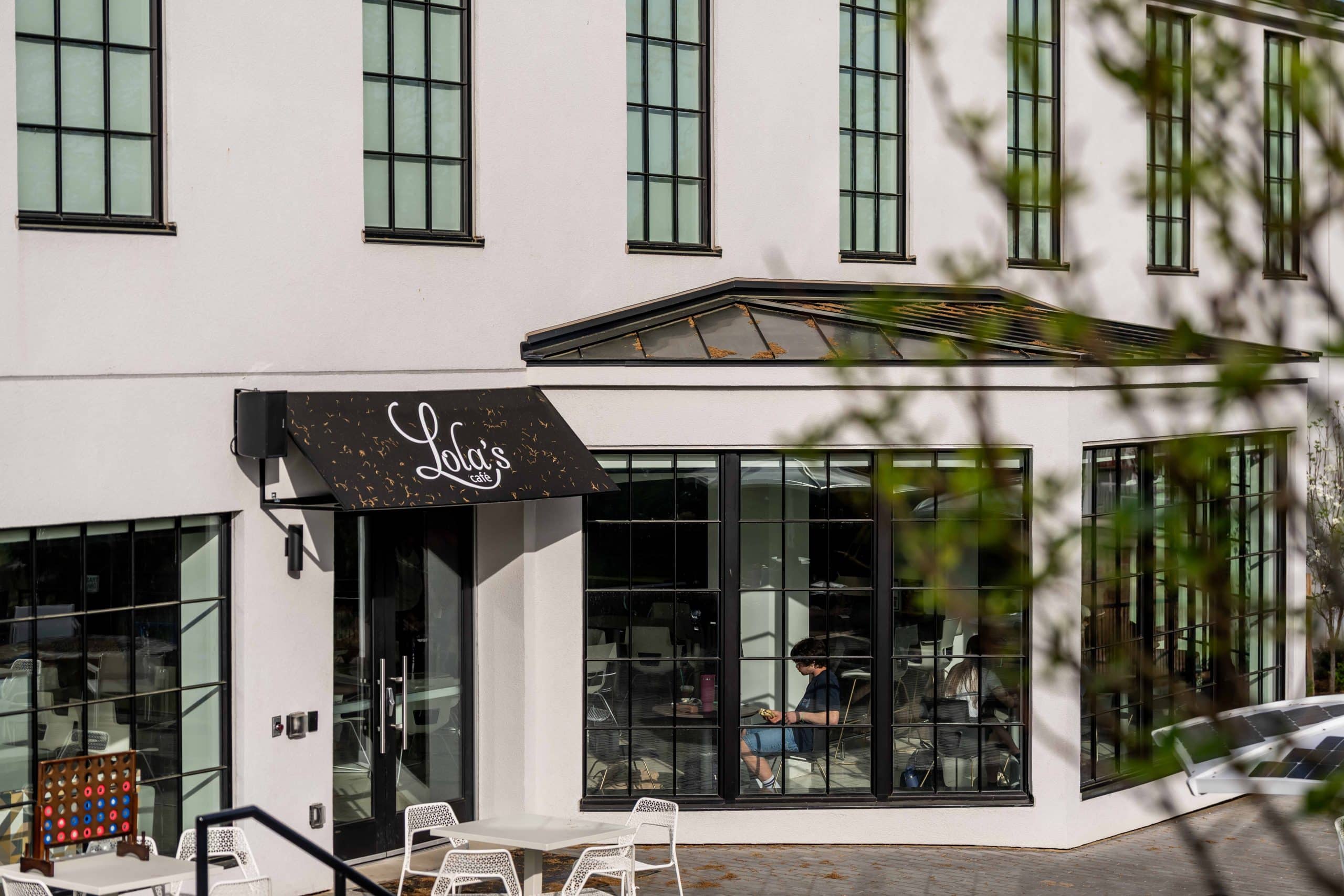 "Lola's" sign on an awning above a patio